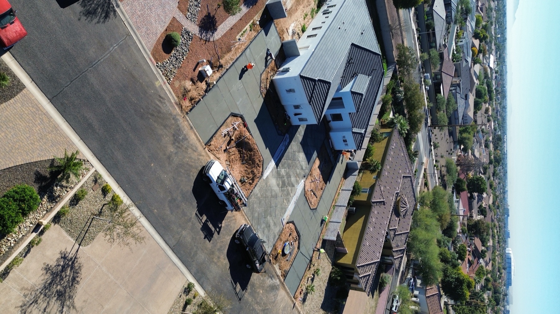 Aerial view — custom home and diagonal-cut driveway pour