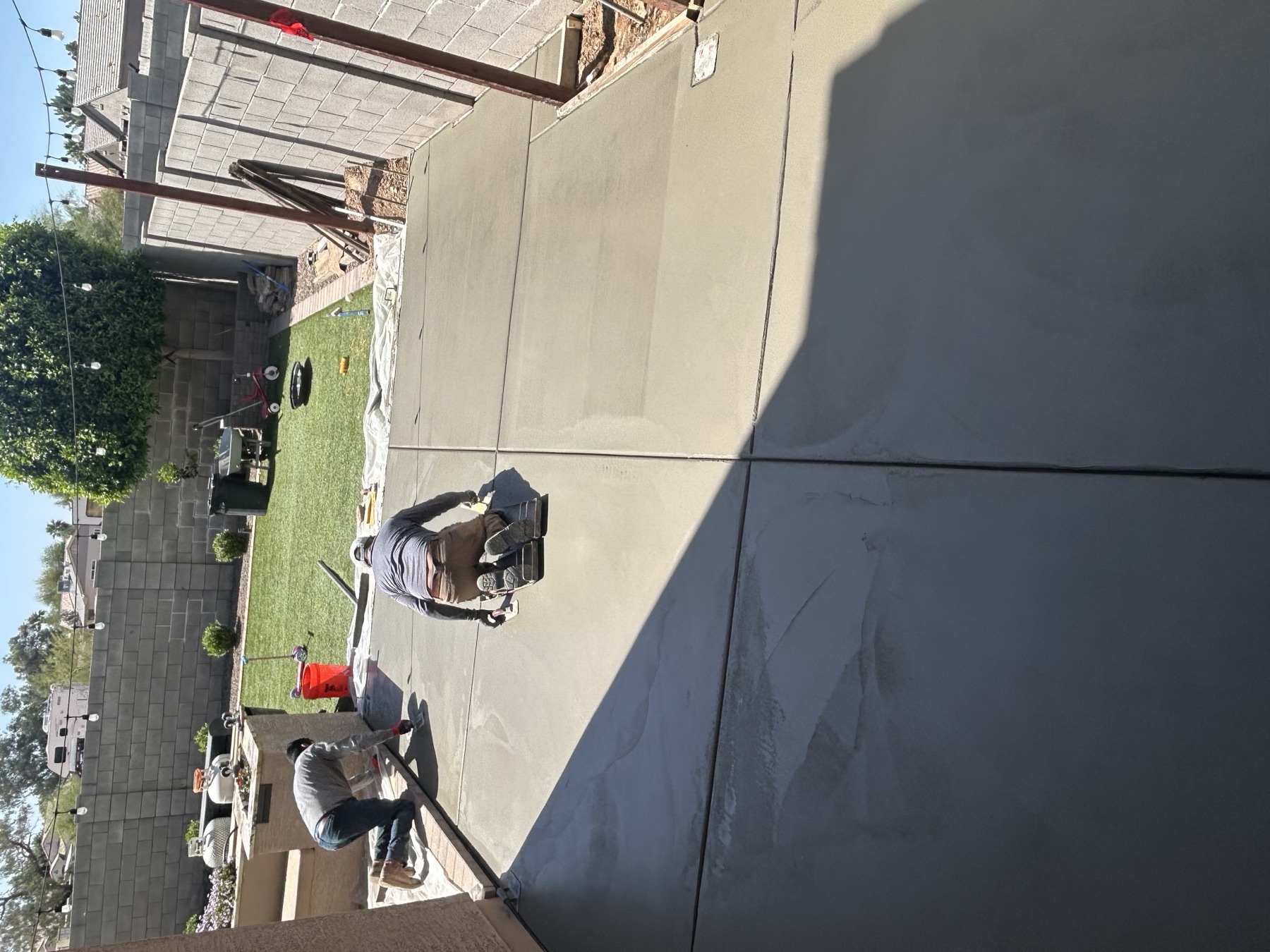 Crew finishing a backyard patio pour