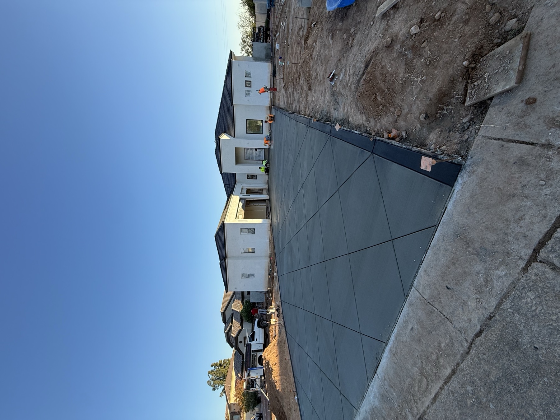 New build driveway pour at dusk