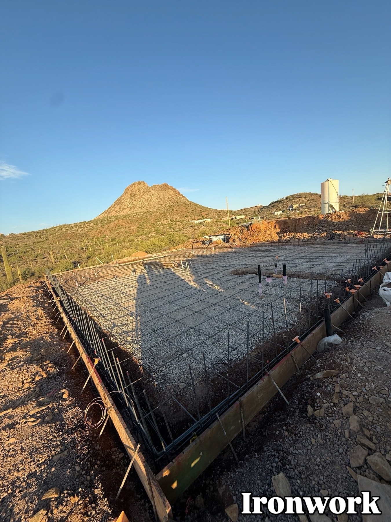 Rebar ironwork foundation prep with mountain backdrop